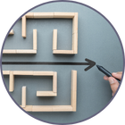 A hand drawing a straight line illustrating the way through a maze